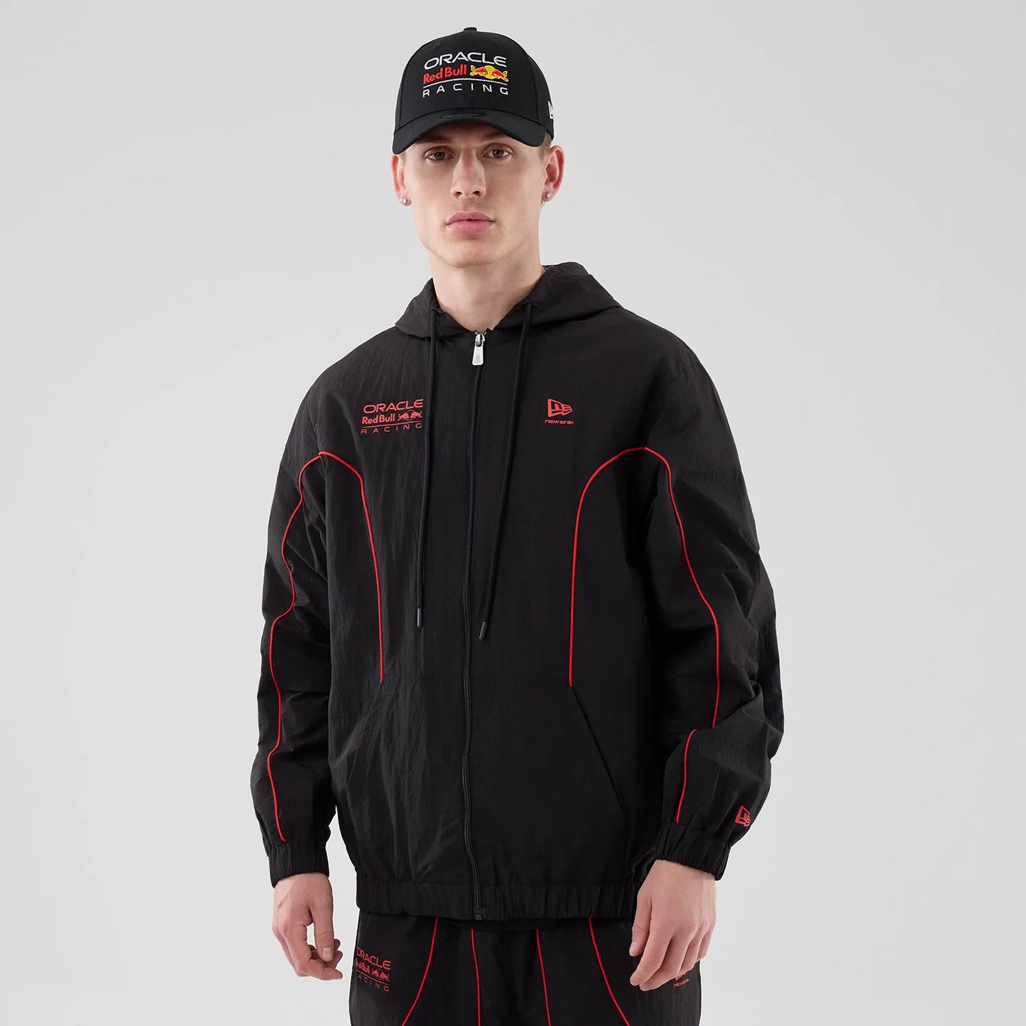 The model is wearing this Red Bull Racing Piping Track Jacket in black. 1
