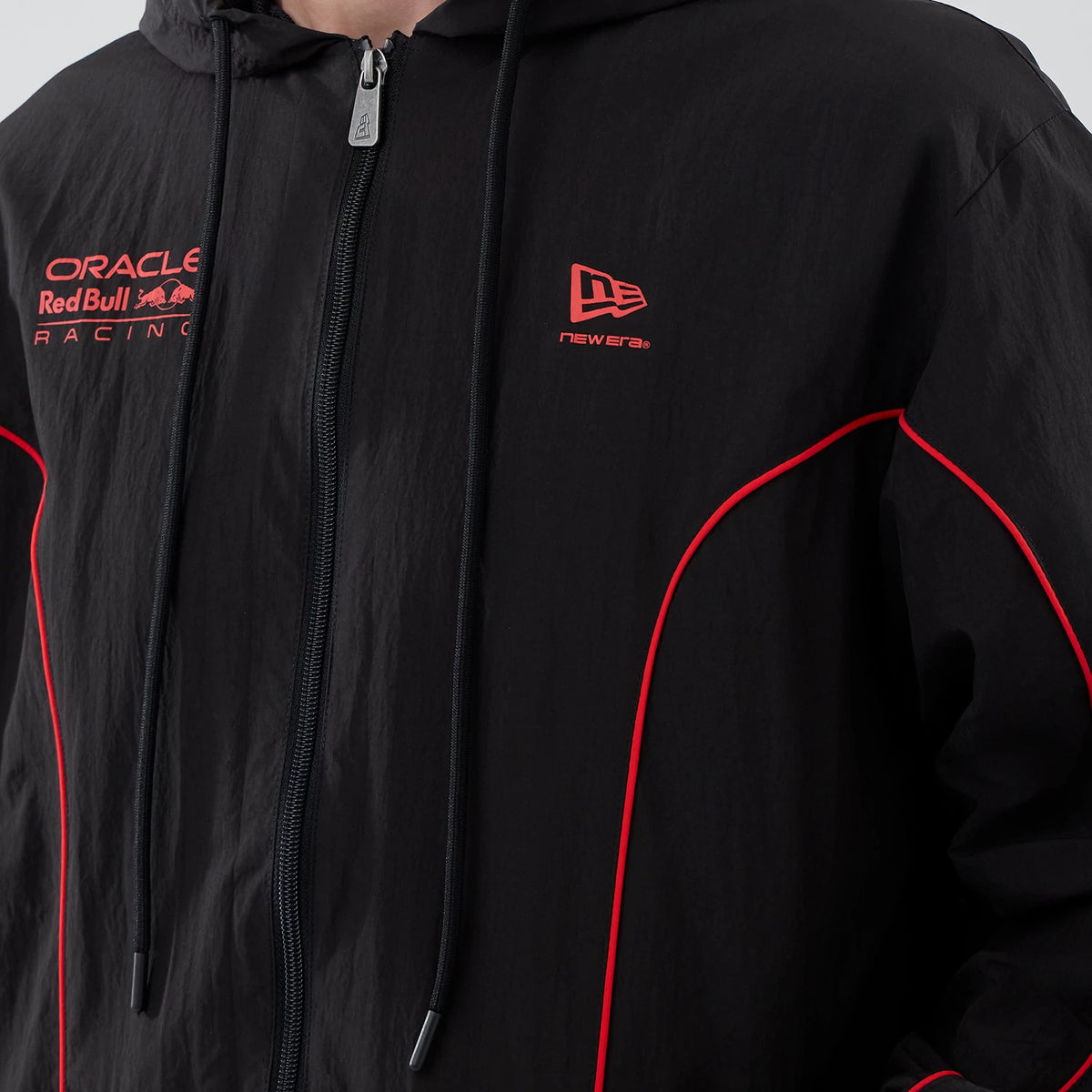 The model is wearing this Red Bull Racing Piping Track Jacket in black. 6