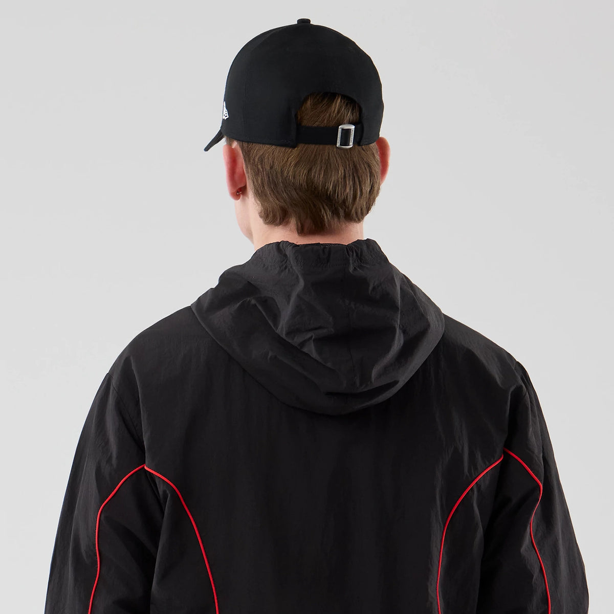 The model is wearing this Red Bull Racing Piping Track Jacket in black. 7
