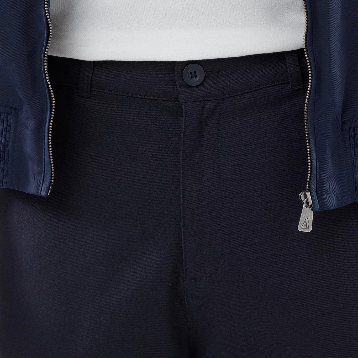 The model is wearing these New Era Chino Trousers in navy. 4