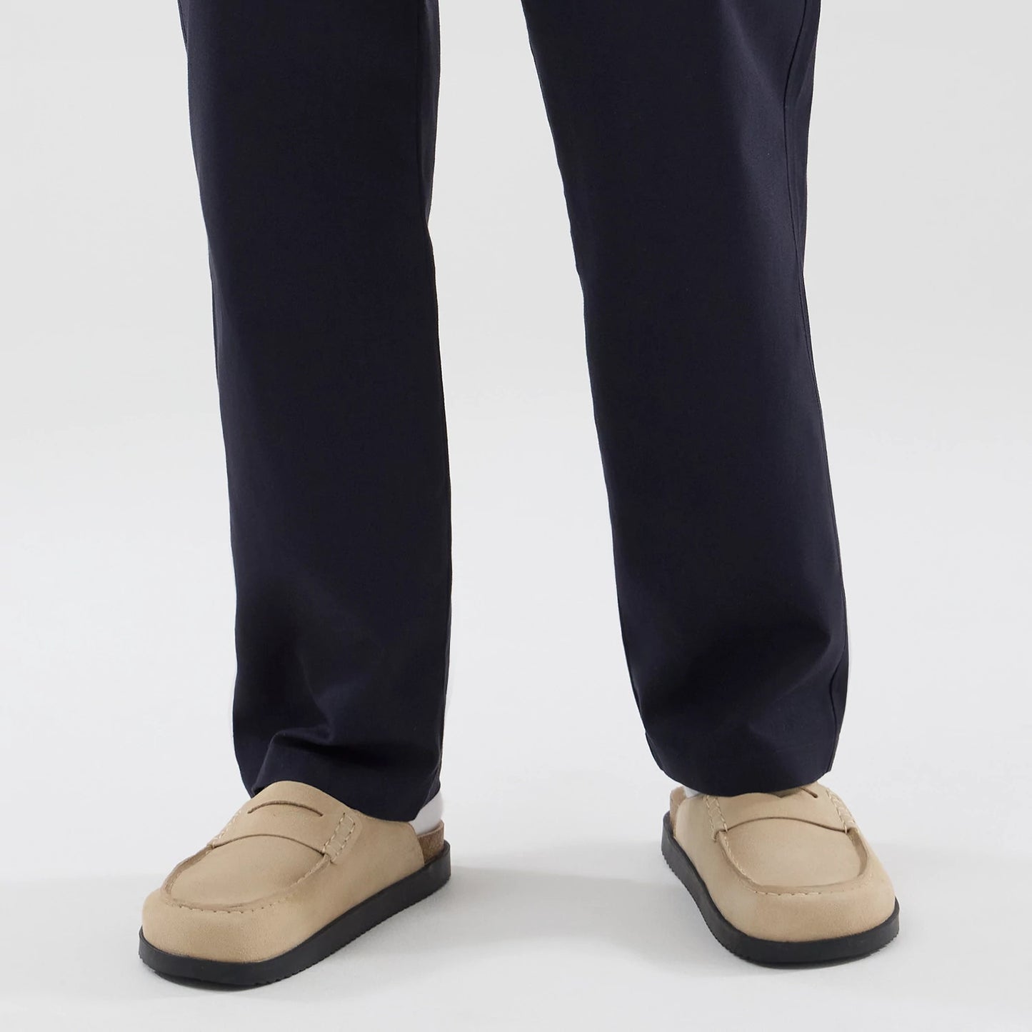 The model is wearing these New Era Chino Trousers in navy. 6