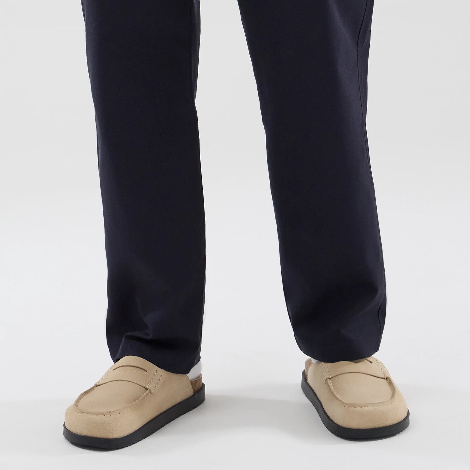 The model is wearing these New Era Chino Trousers in navy. 6