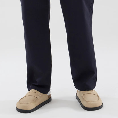 The model is wearing these New Era Chino Trousers in navy. 6