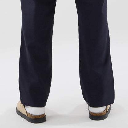 The model is wearing these New Era Chino Trousers in navy. 7