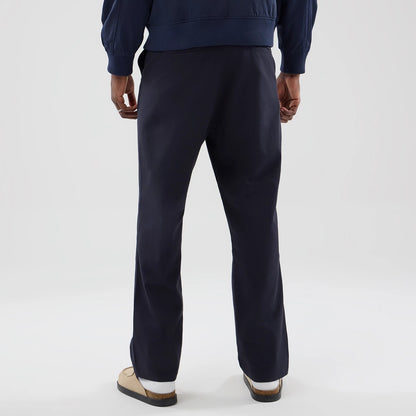 The model is wearing these New Era Chino Trousers in navy. 2