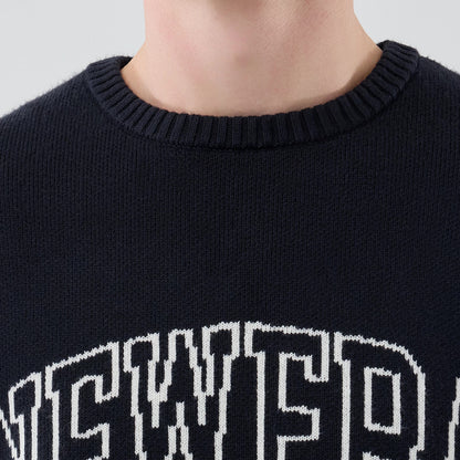 The model is wearing this New Era Knit Script Knitted Sweater in navy. 5