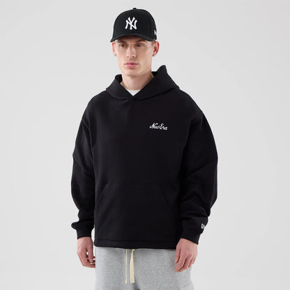 The model is wearing this New Era Open Hem Pullover Hoodie in black. 1