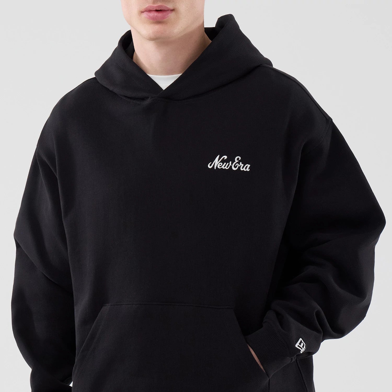 The model is wearing this New Era Open Hem Pullover Hoodie in black. 3