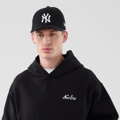 The model is wearing this New Era Open Hem Pullover Hoodie in black. 5