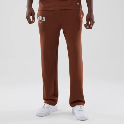 The model is wearing these NBA Core Plus Chicago Bulls Straight Leg Joggers in brown. 1