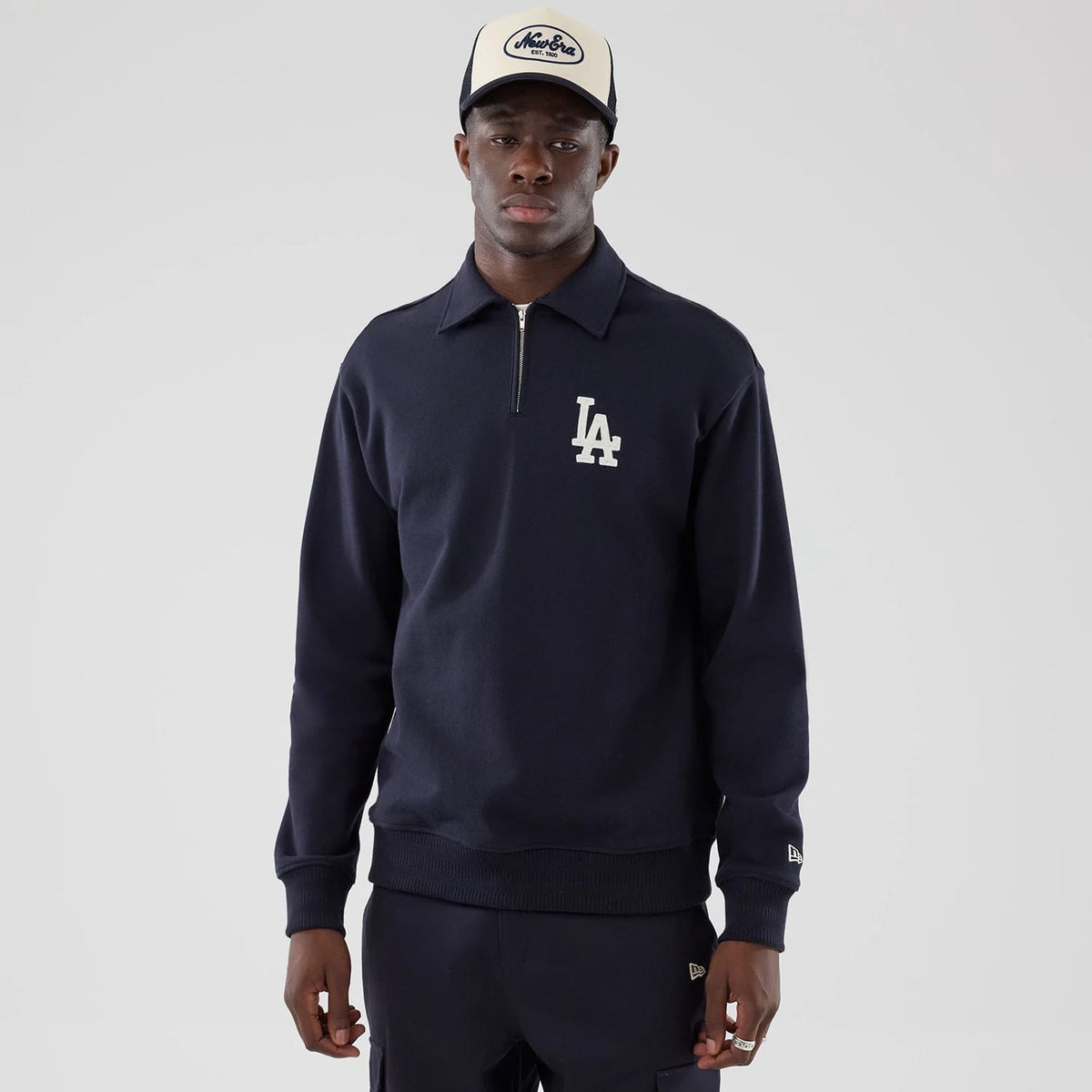 The model is wearing this MLB LA Dodgers Oversized 1/4 Zip Sweater in navy. 1