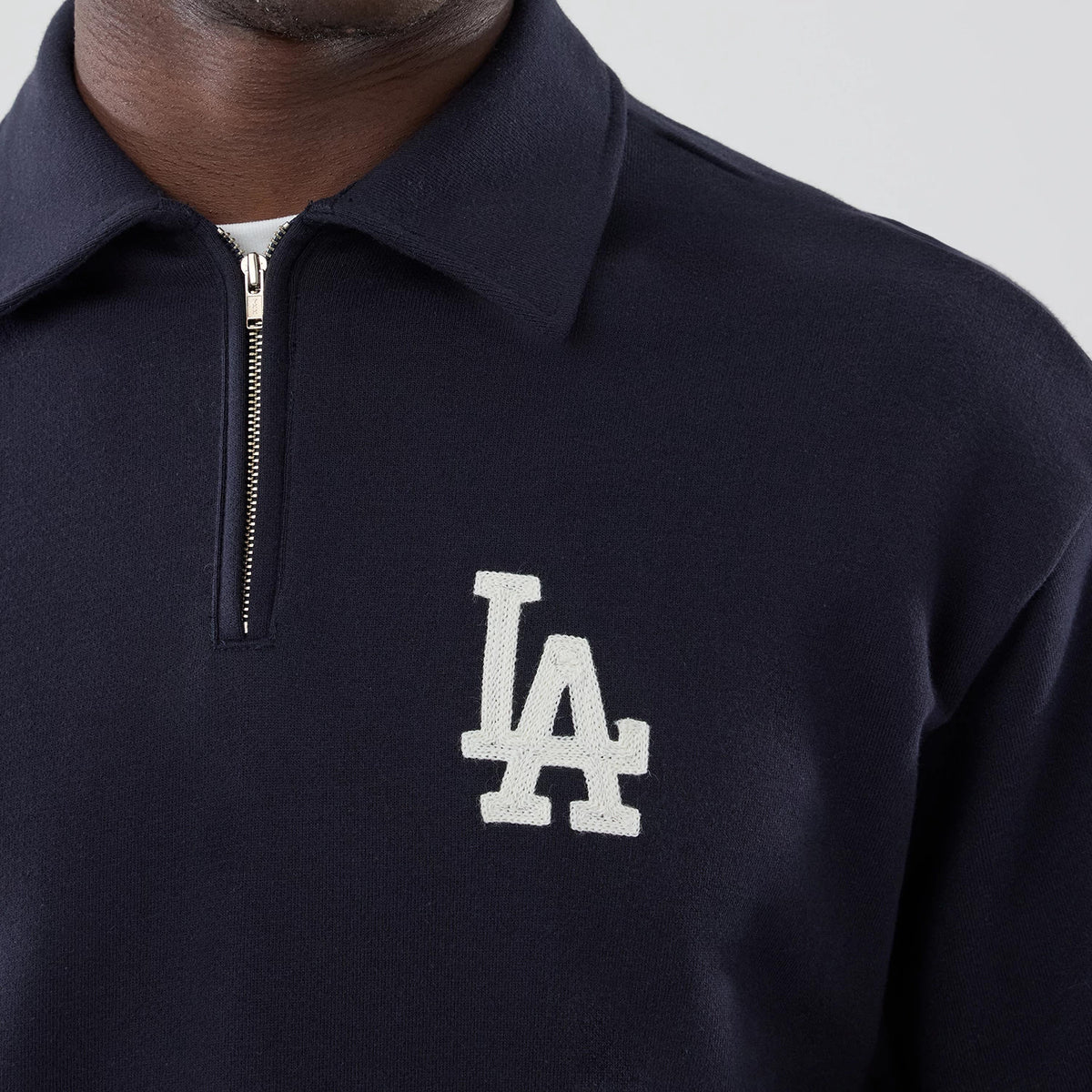 The model is wearing this MLB LA Dodgers Oversized 1/4 Zip Sweater in navy. 4