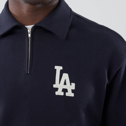 New Era LA Dodgers MLB Navy Oversized 1/4 Zip Sweater, front view on a model showing the white embroidered LA logo on the left chest, a silver quarter-zip closure, and a dark navy fabric with a classic collar design.