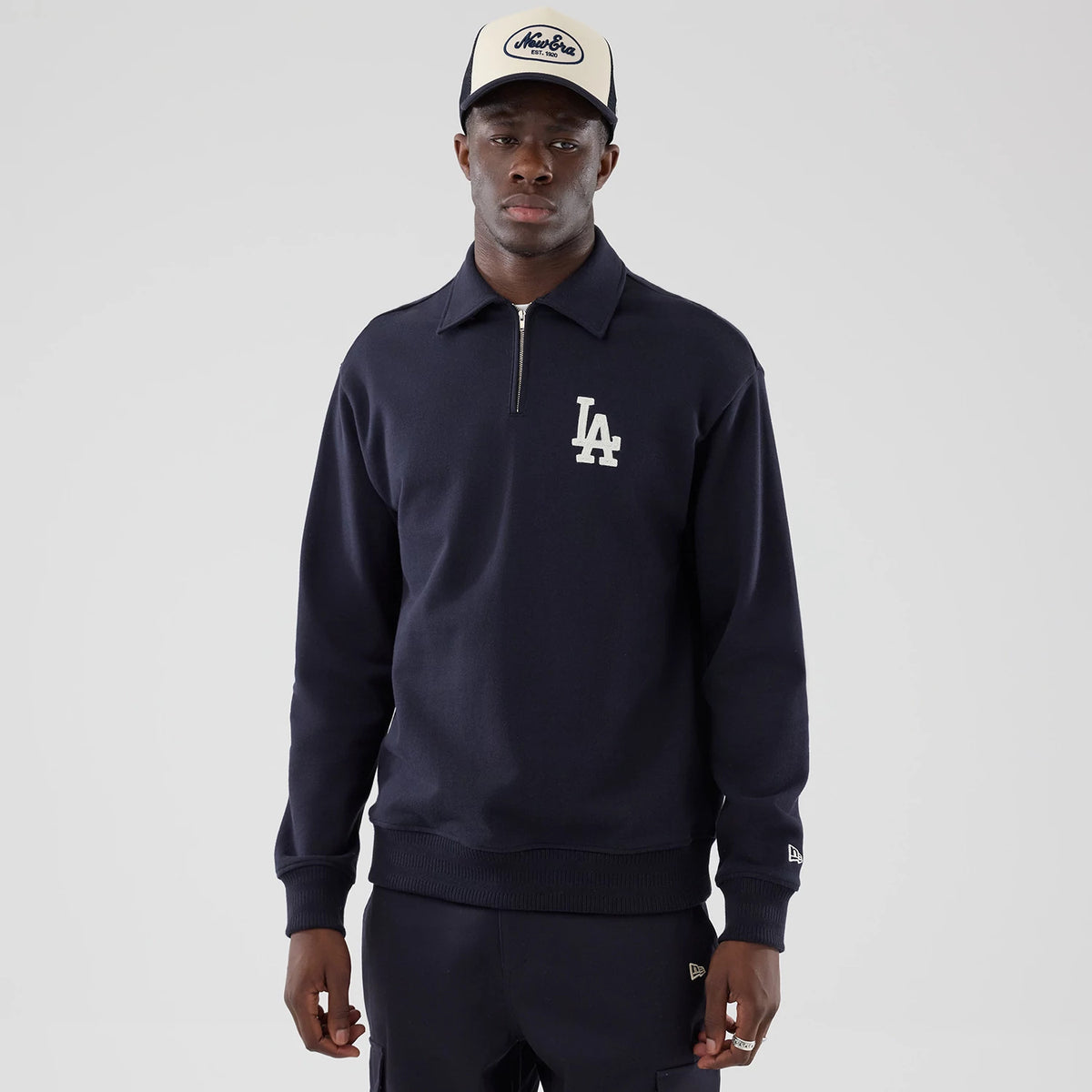 The model is wearing this MLB LA Dodgers Oversized 1/4 Zip Sweater in navy. 1