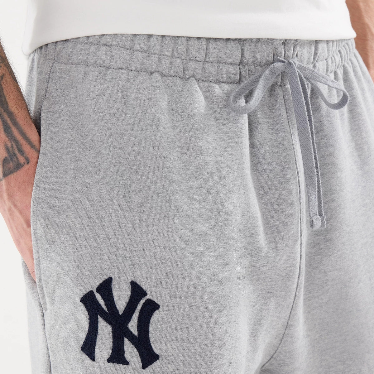 The model is wearing these MLB Straight Leg New York Yankees Straight Leg Joggers in grey. 3