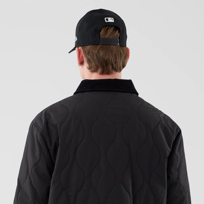 The model is wearing this New Era Quilted Coaches Jacket in black. 7