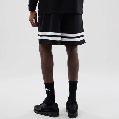 The model is wearing these MLB Mesh LA Dodgers Oversized Shorts in black. 2