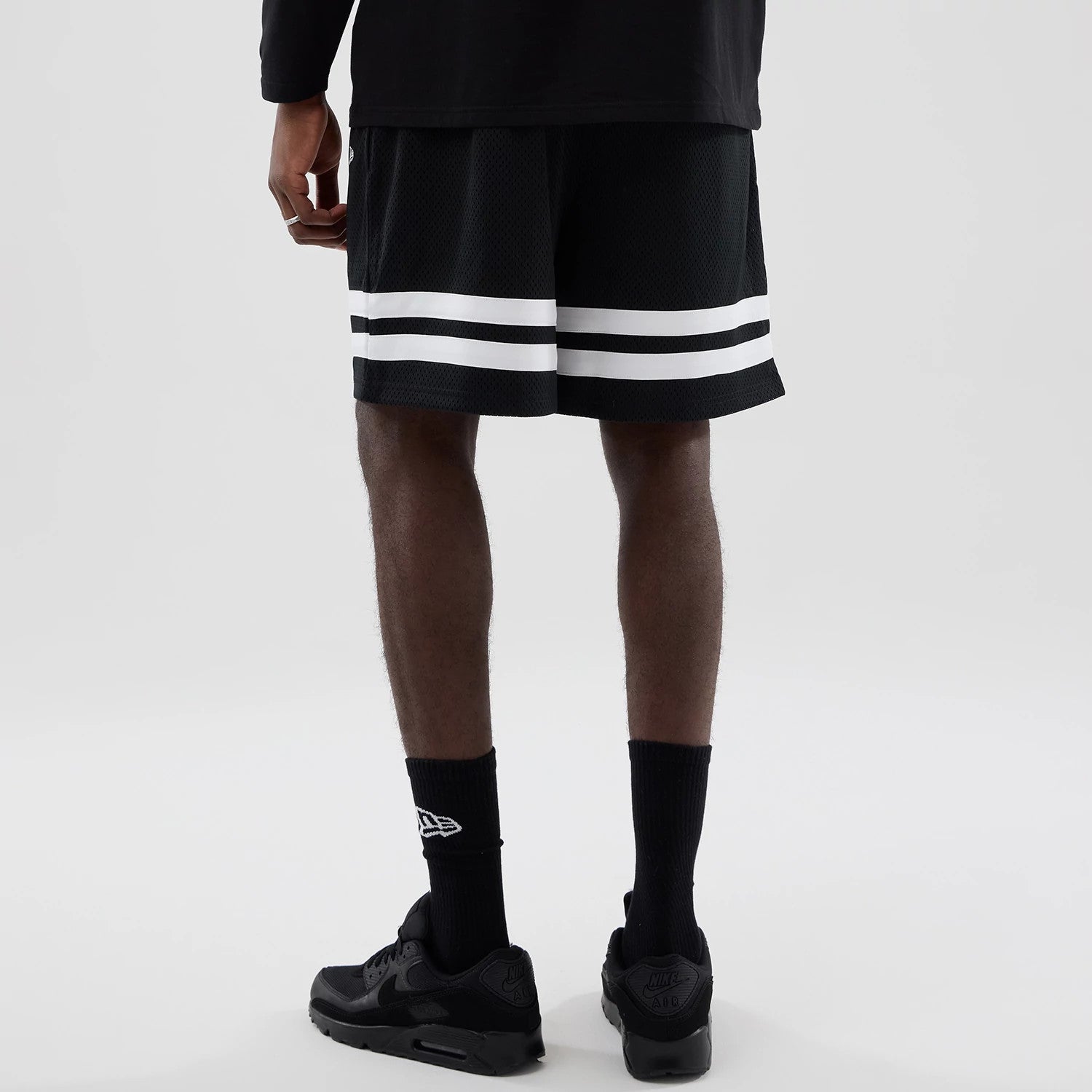 The model is wearing these MLB Mesh LA Dodgers Oversized Shorts in black. 2