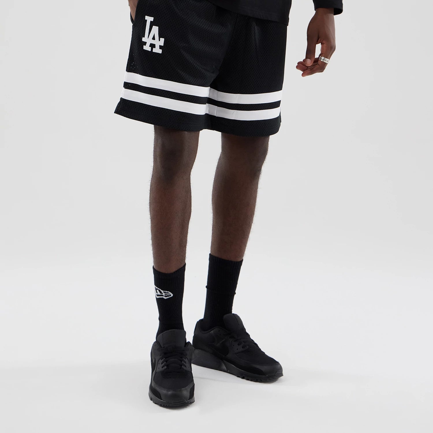 The model is wearing these MLB Mesh LA Dodgers Oversized Shorts in black. 1