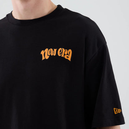 The model is wearing this New Era Hot Dog Graphic Oversized T-Shirt in black. 5