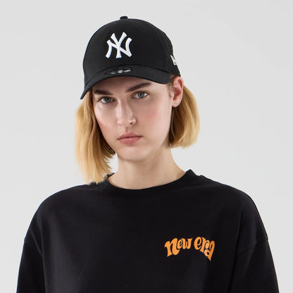 The model is wearing this New Era Food Graphic Oversized T-Shirt in black. 6