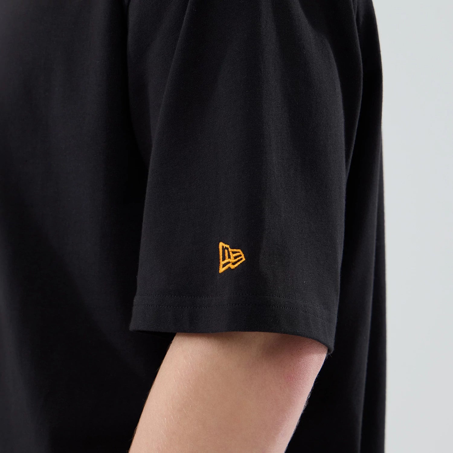 The model is wearing this New Era Hot Dog Graphic Oversized T-Shirt in black. 7