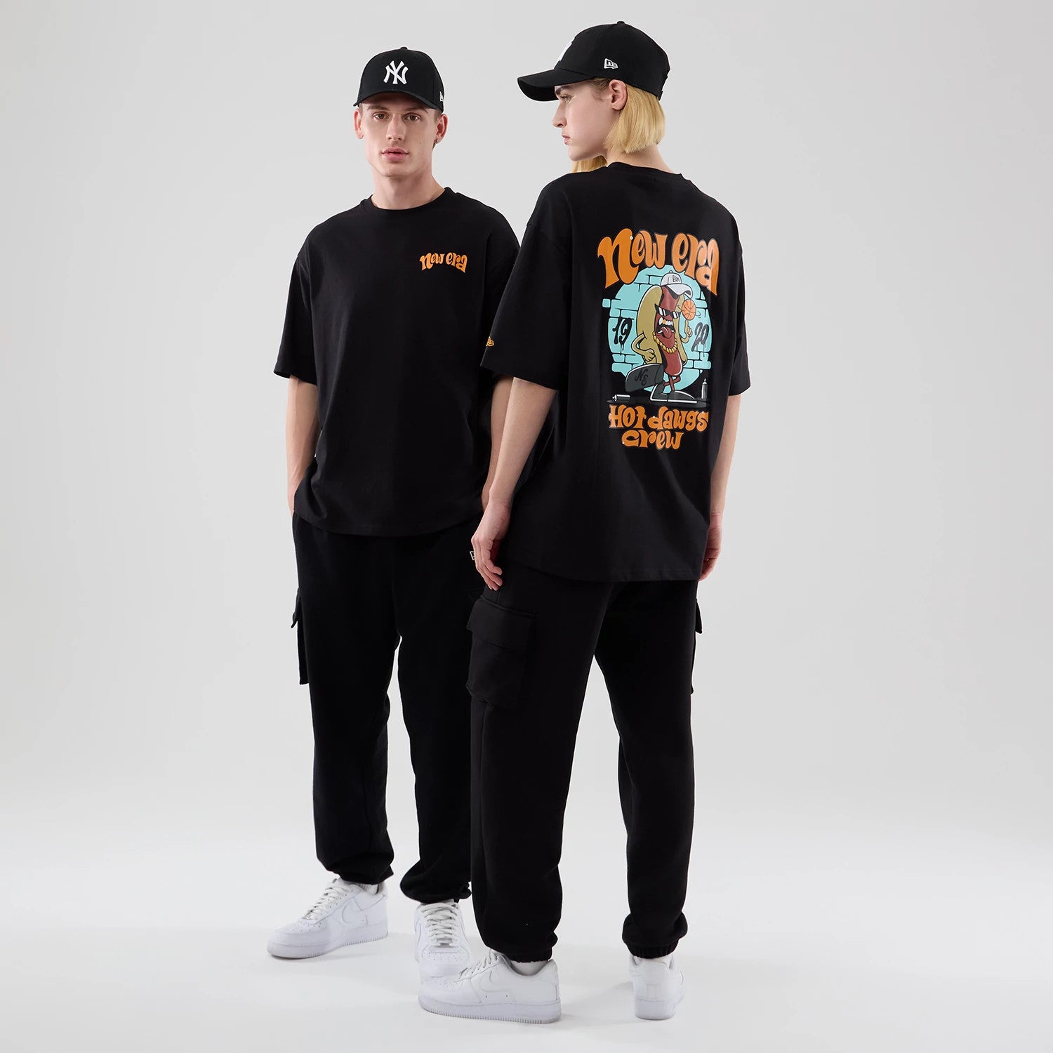 The model is wearing this New Era Hot Dog Graphic Oversized T-Shirt in black. 1
