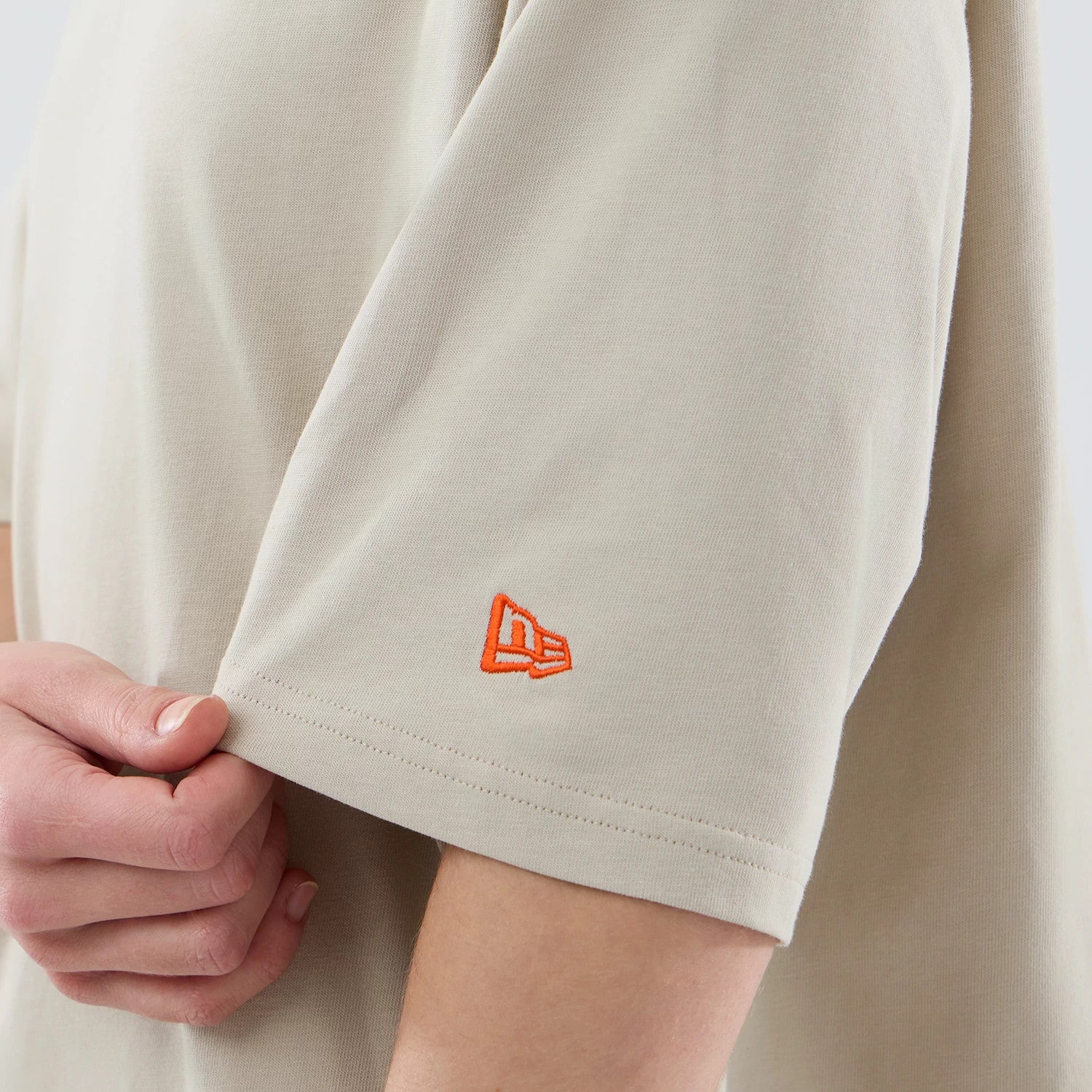 The model is wearing this New Era Food Graphic Oversized T-Shirt in light beige. 7
