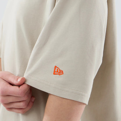 The model is wearing this New Era Food Graphic Oversized T-Shirt in light beige. 7