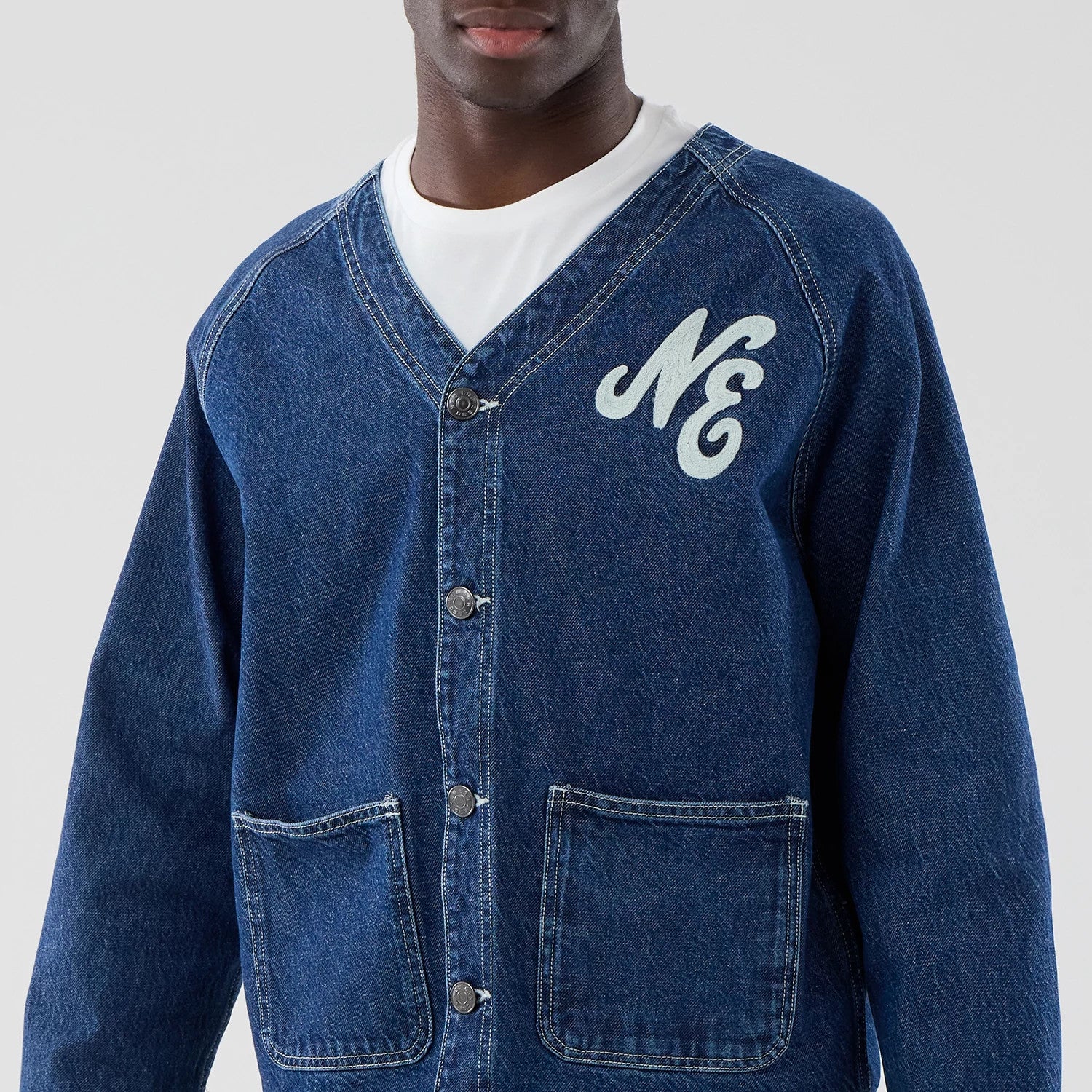 The model is wearing this New Era Denim Worker Jacket in dark blue. 3