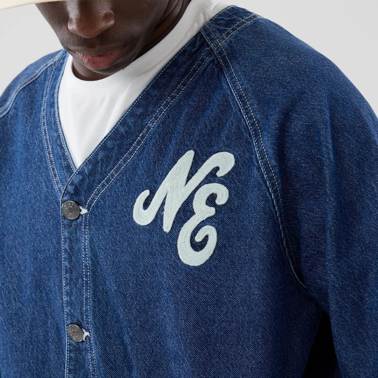 The model is wearing this New Era Denim Worker Jacket in dark blue. 4