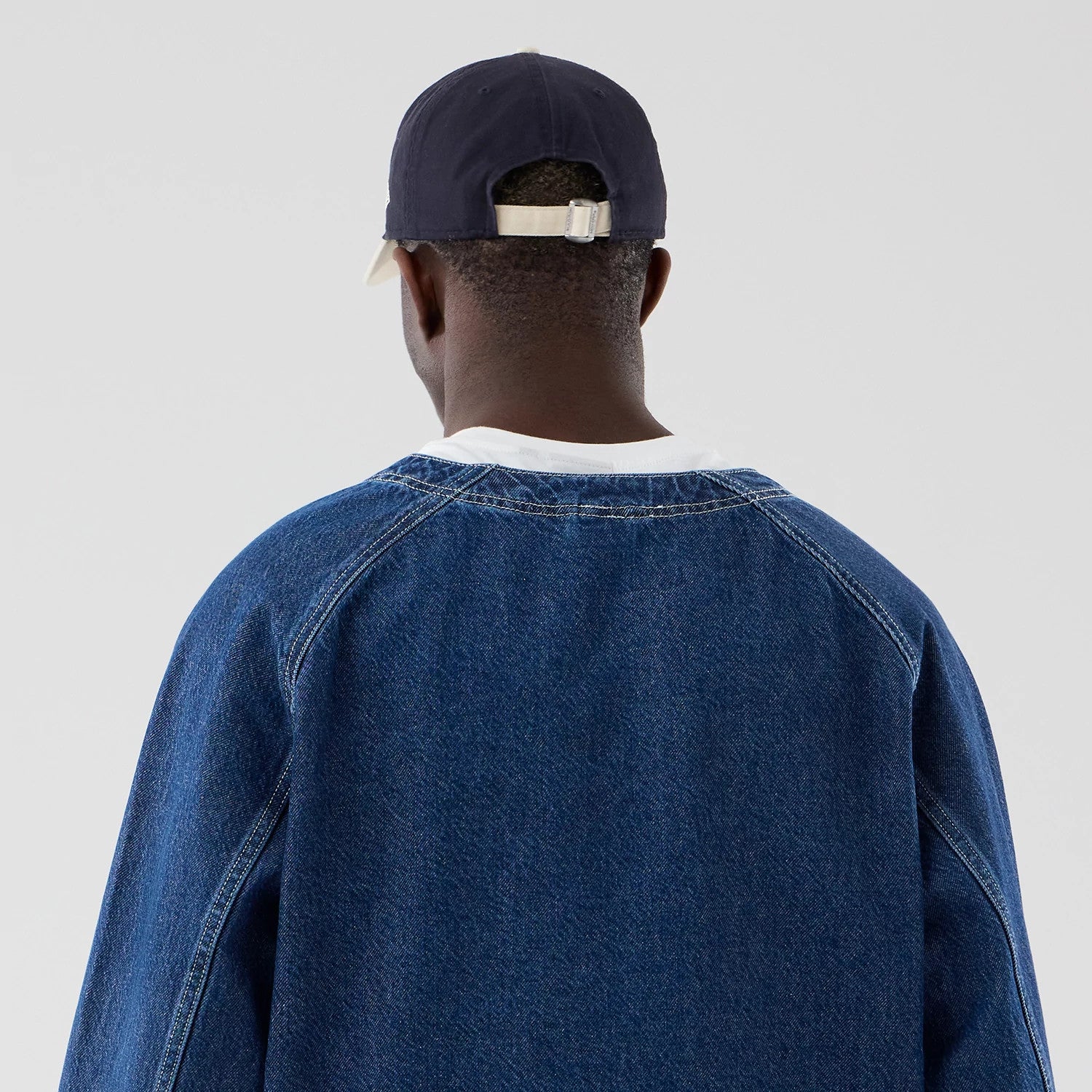 The model is wearing this New Era Denim Worker Jacket in dark blue. 7