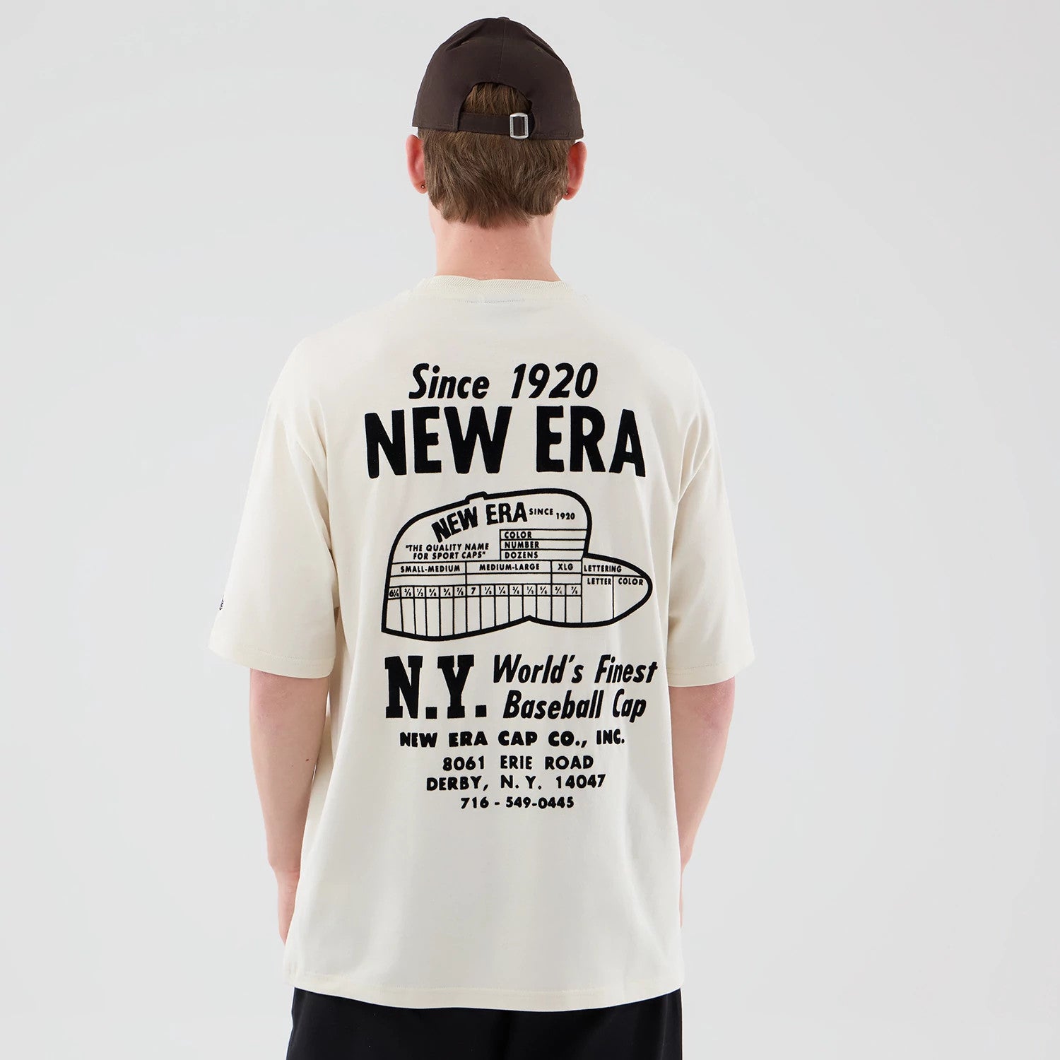 The model is wearing this New Era Cap Graphic Oversized T-Shirt in cream. 2