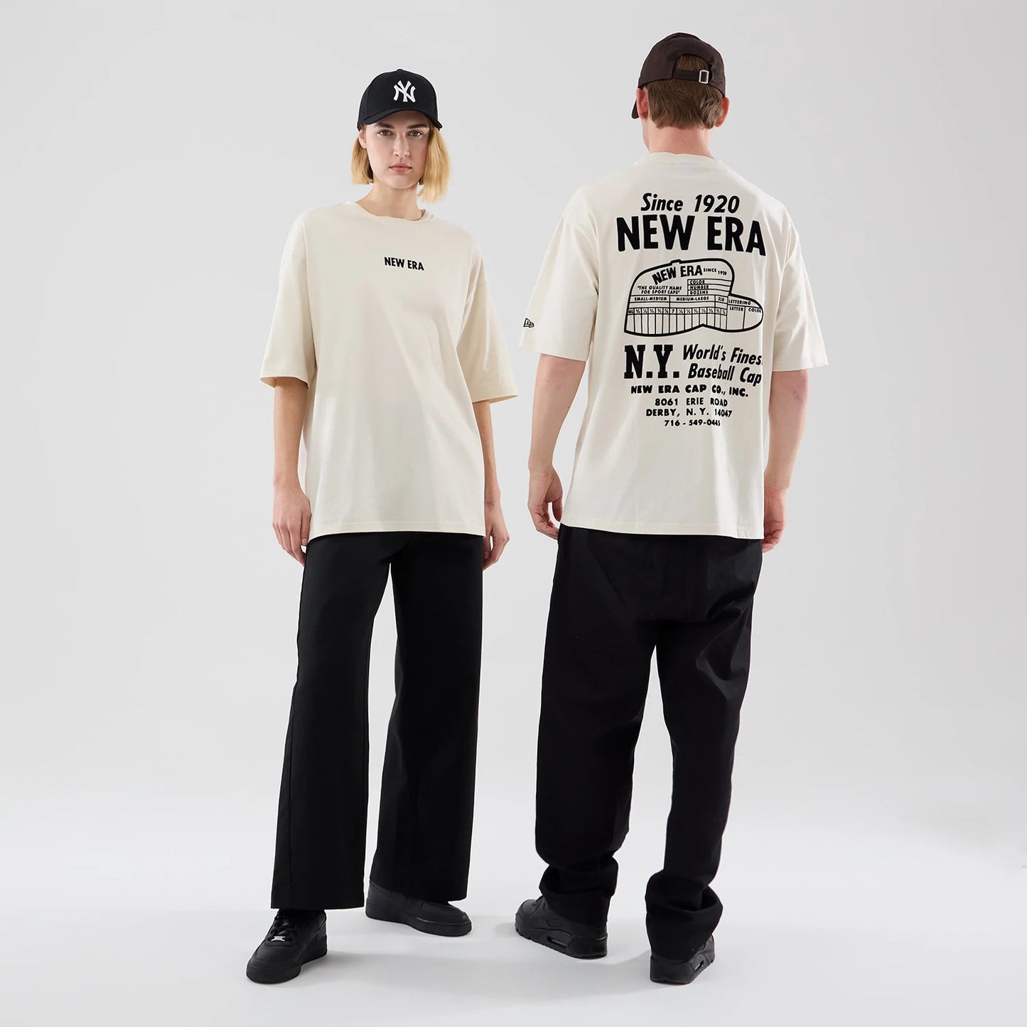 The model is wearing this New Era Cap Graphic Oversized T-Shirt in cream. 1