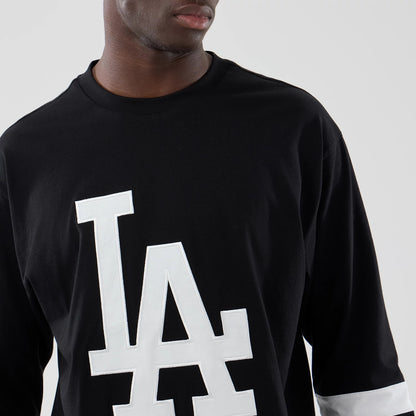 The model is wearing this MLB LA Dodgers Oversized Long Sleeve T-Shirt in black. 5