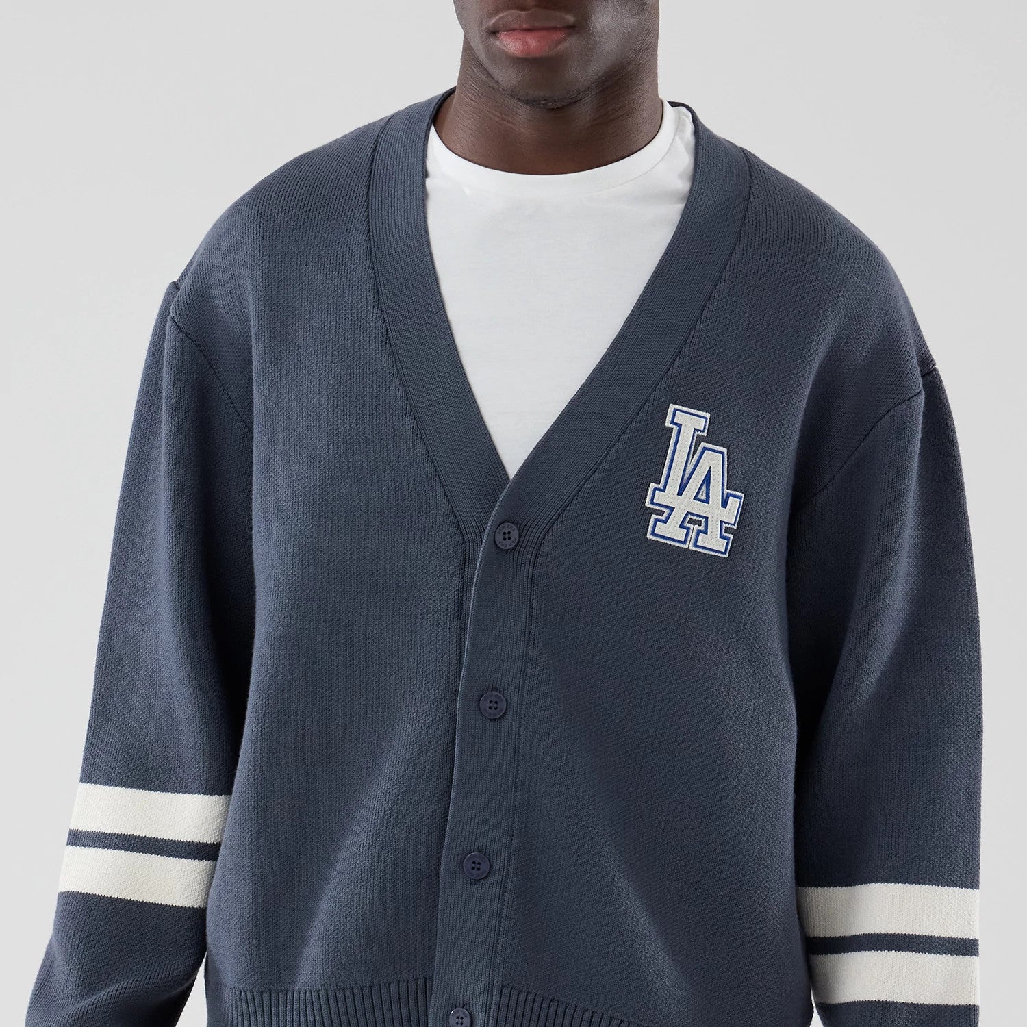 The model is wearing this MLB Knit LA Dodgers Cardigan in grey. 3