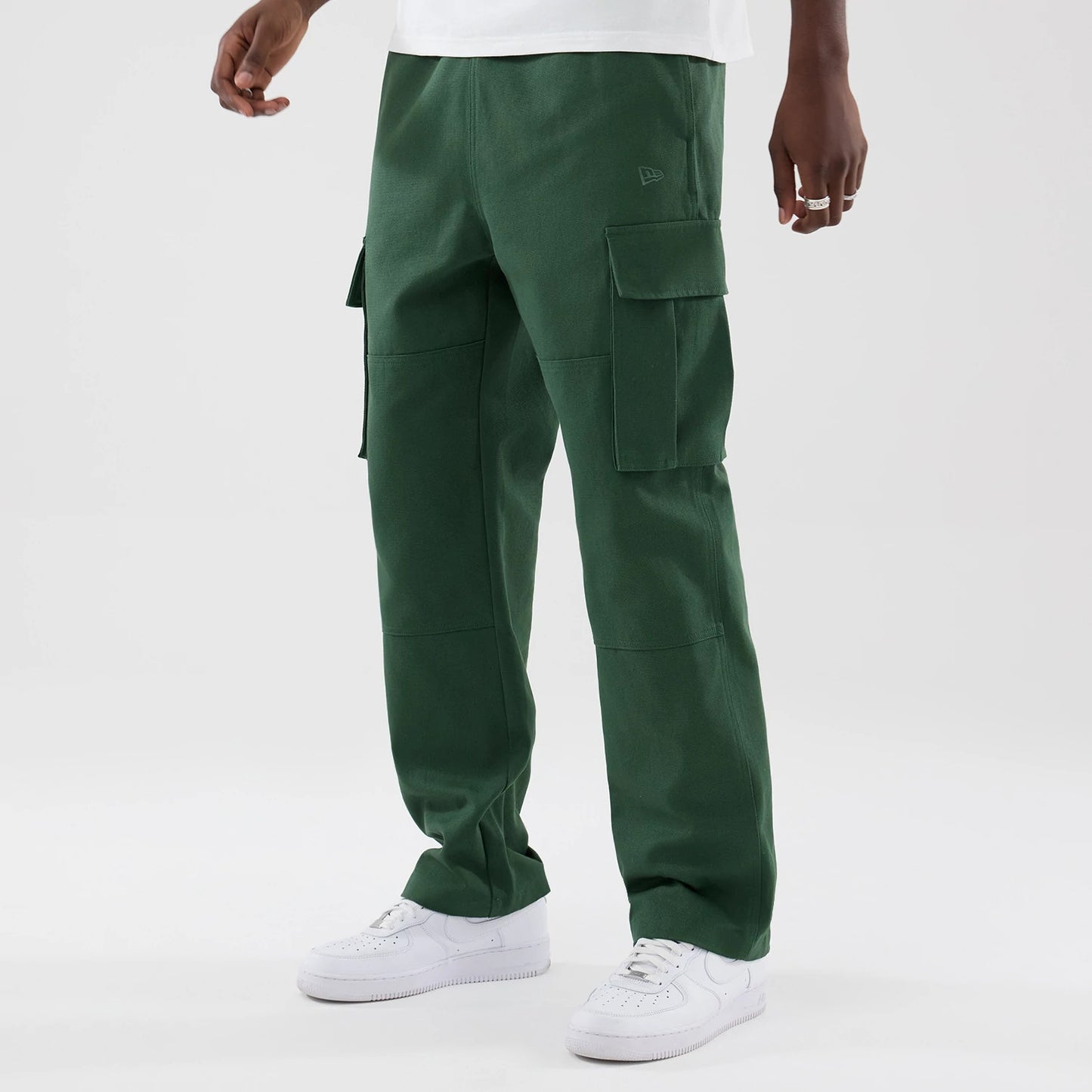 The model is wearing these New Era Cargo Trousers in dark green. 3