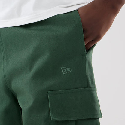 The model is wearing these New Era Cargo Trousers in dark green. 5