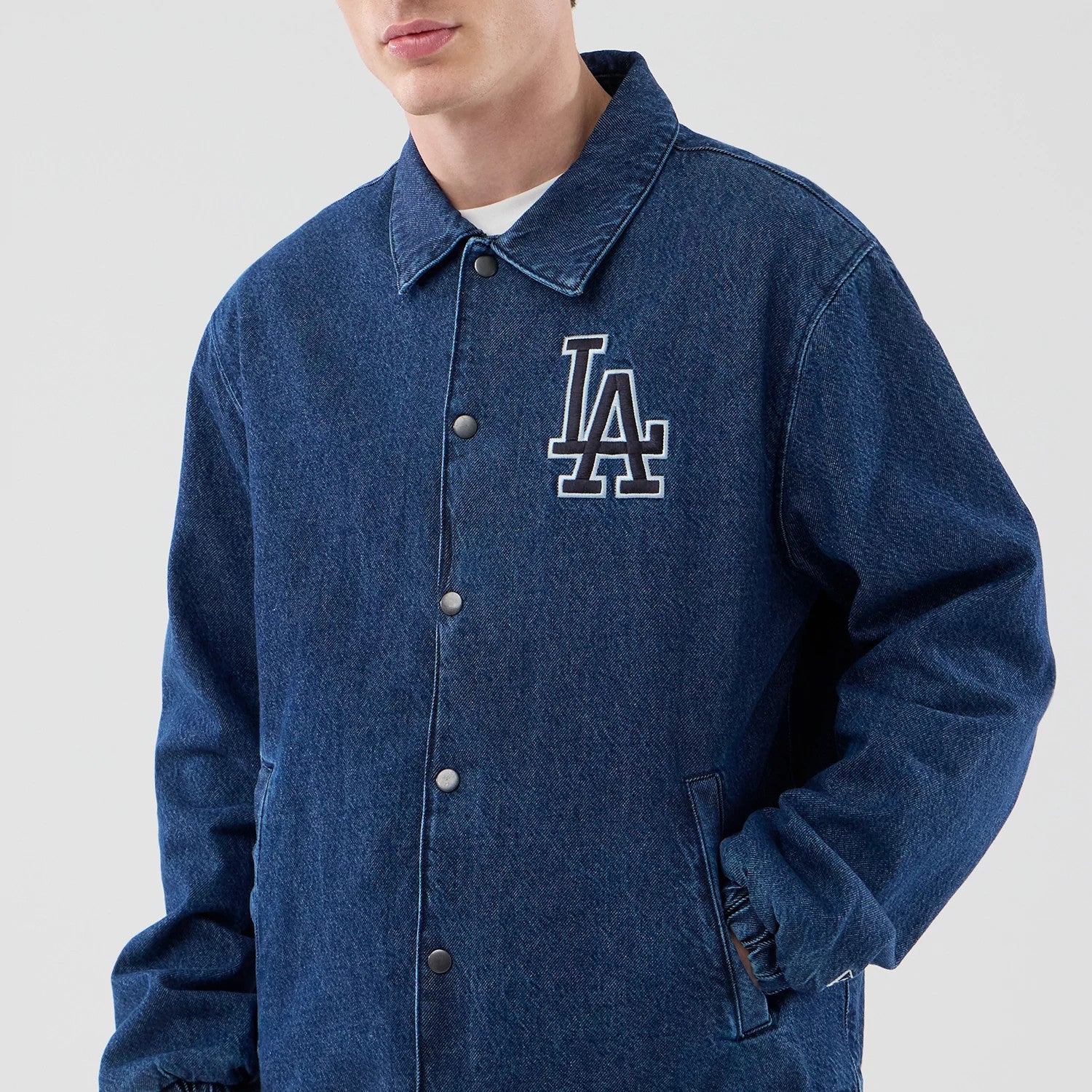 The model is wearing this MLB Coaches LA Dodgers Jacket in dark blue. 3