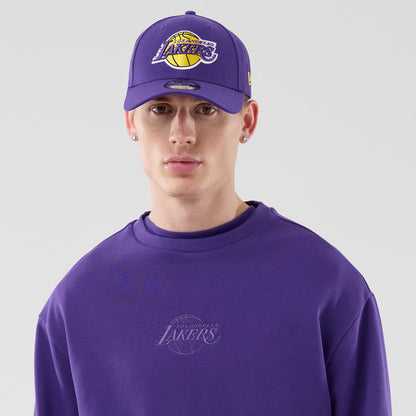 The model is wearing this NBA League Essential LA Lakers Oversized Crew Neck Sweater in purple. 6