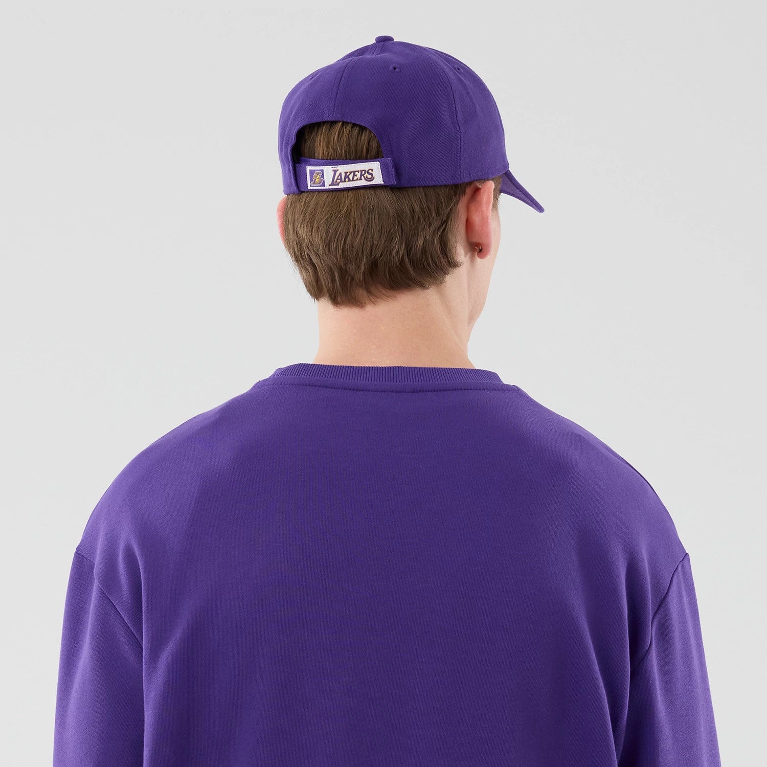 The model is wearing this NBA League Essential LA Lakers Oversized Crew Neck Sweater in purple. 7