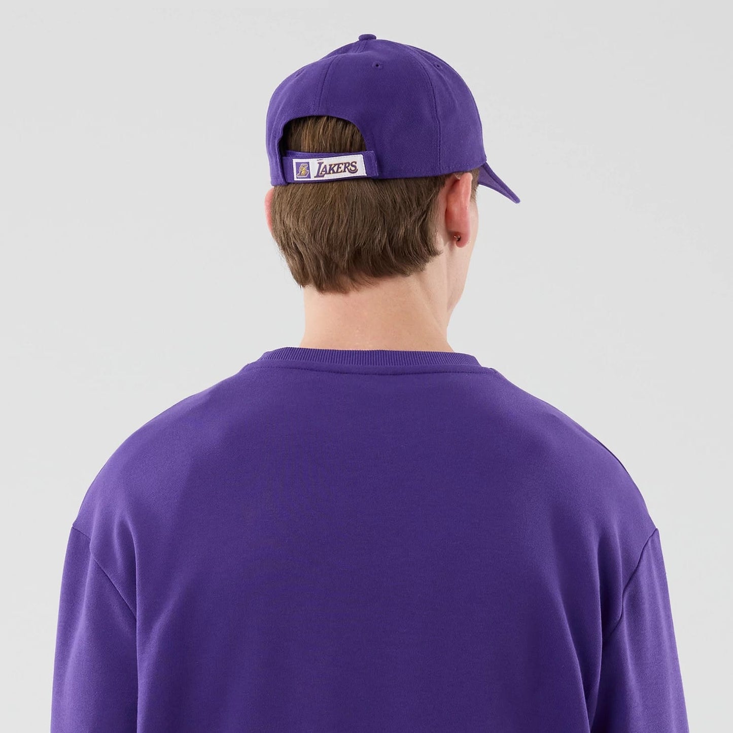 The model is wearing this NBA League Essential LA Lakers Oversized Crew Neck Sweater in purple. 7