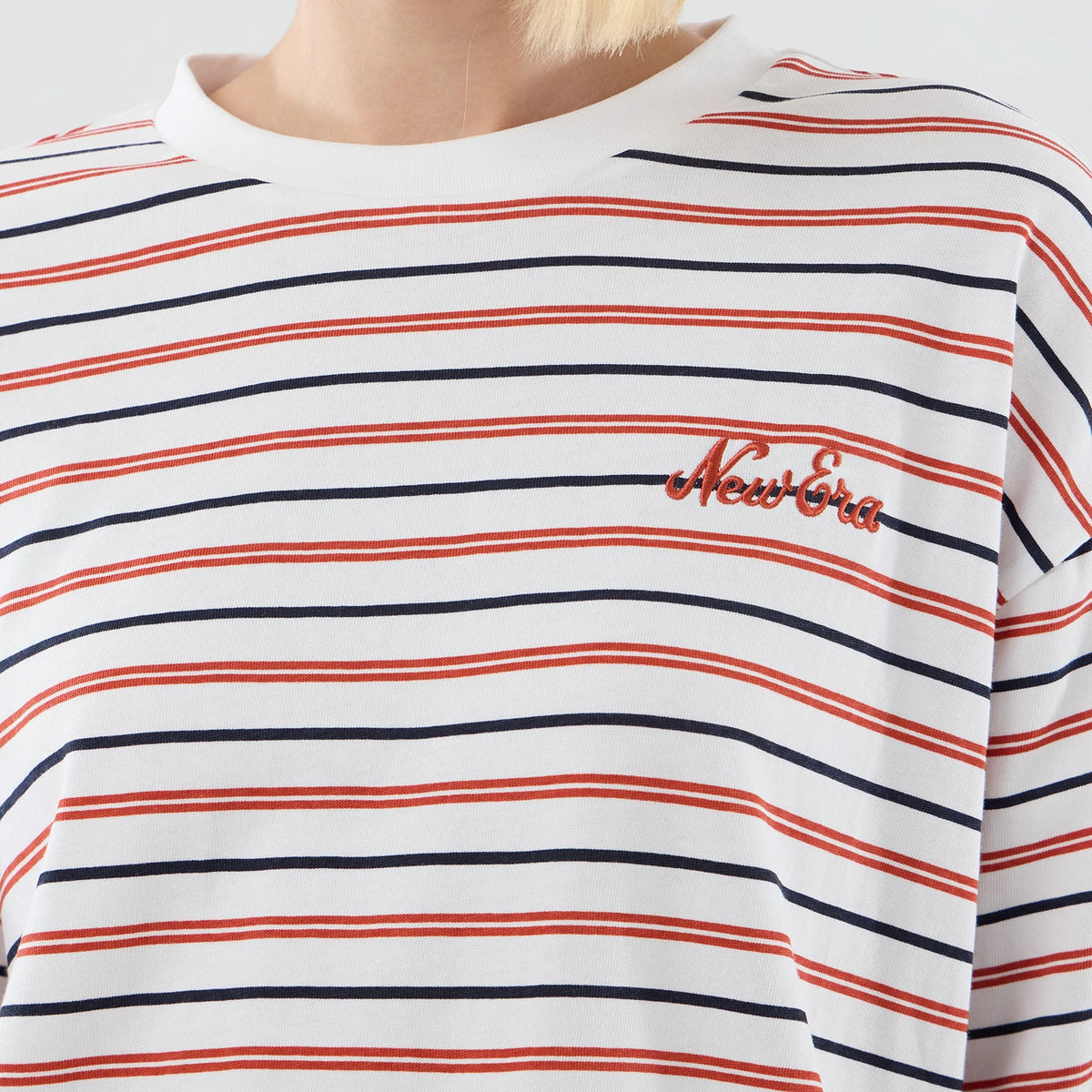 The model is wearing this New Era Stripe Oversized T-Shirt in white. 6