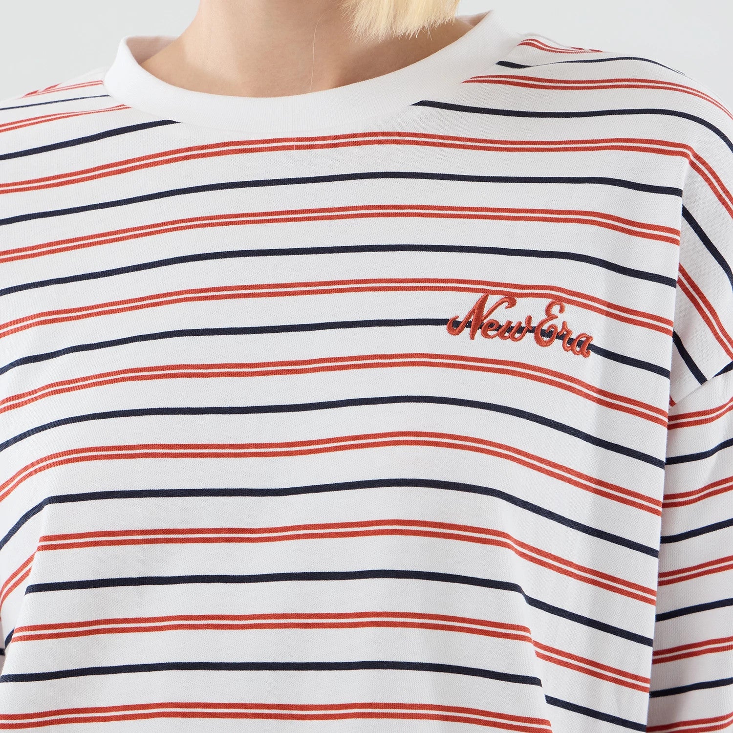 The model is wearing this New Era Stripe Oversized T-Shirt in white. 6