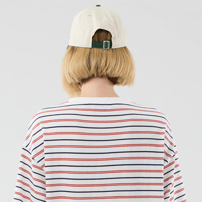 The model is wearing this New Era Stripe Oversized T-Shirt in white. 8
