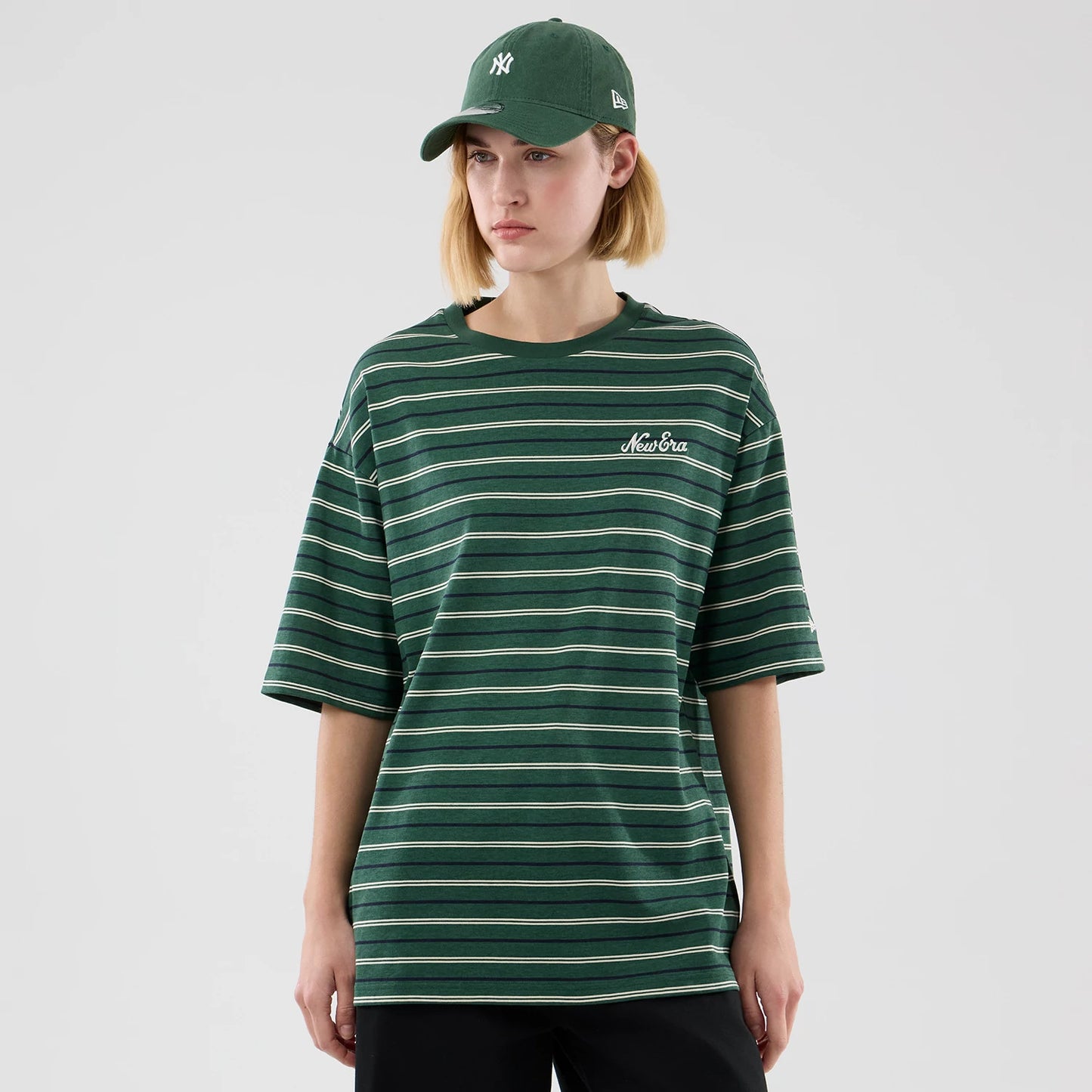 The model is wearing this New Era Stripe Oversized T-Shirt in dark green. 4