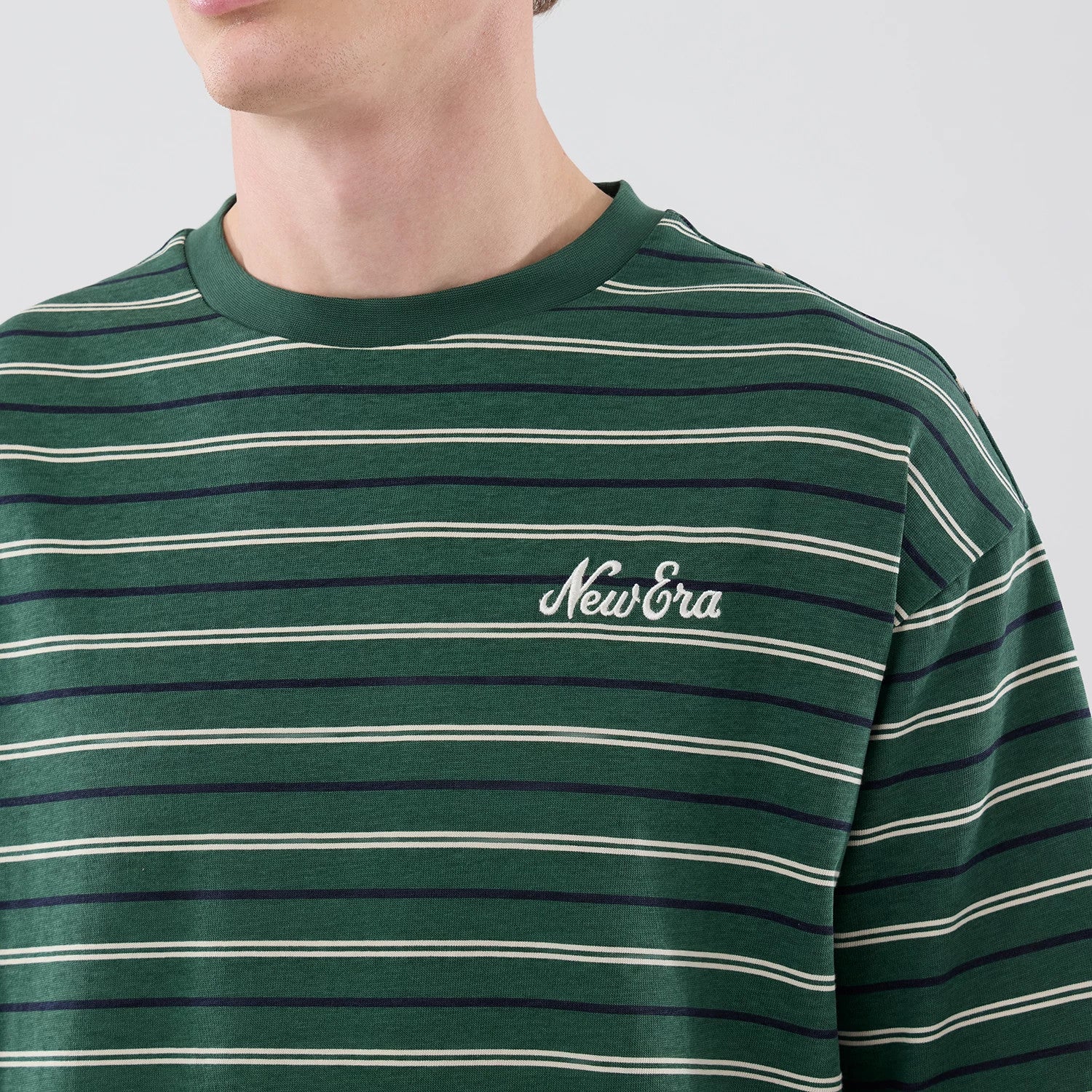The model is wearing this New Era Stripe Oversized T-Shirt in dark green. 5