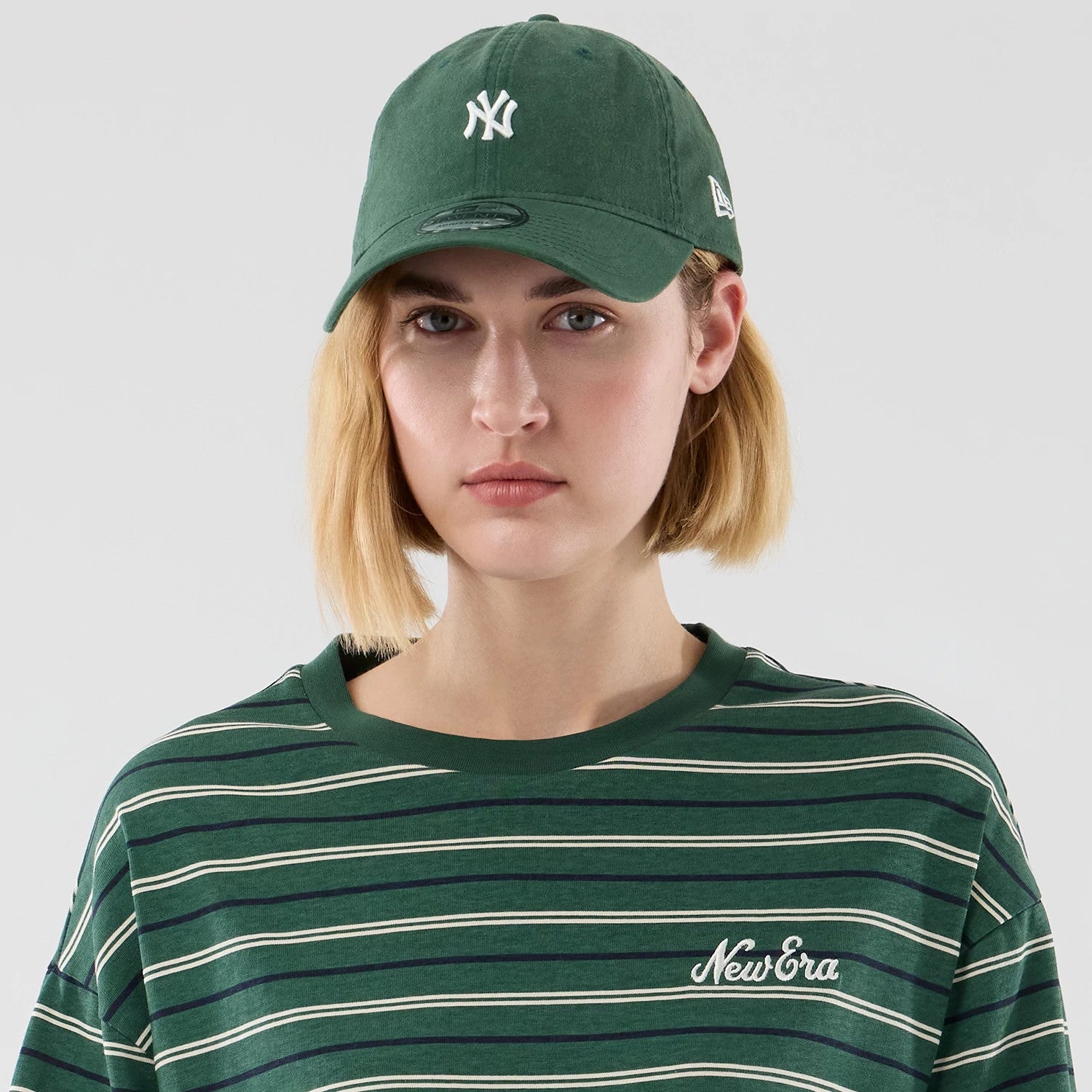 The model is wearing this New Era Stripe Oversized T-Shirt in dark green. 6