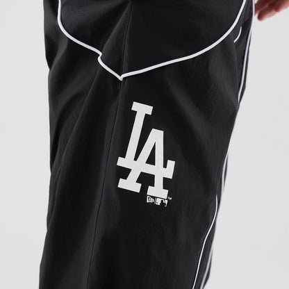The model is wearing these MLB Piping Track LA Dodgers Track Pants in black. 5