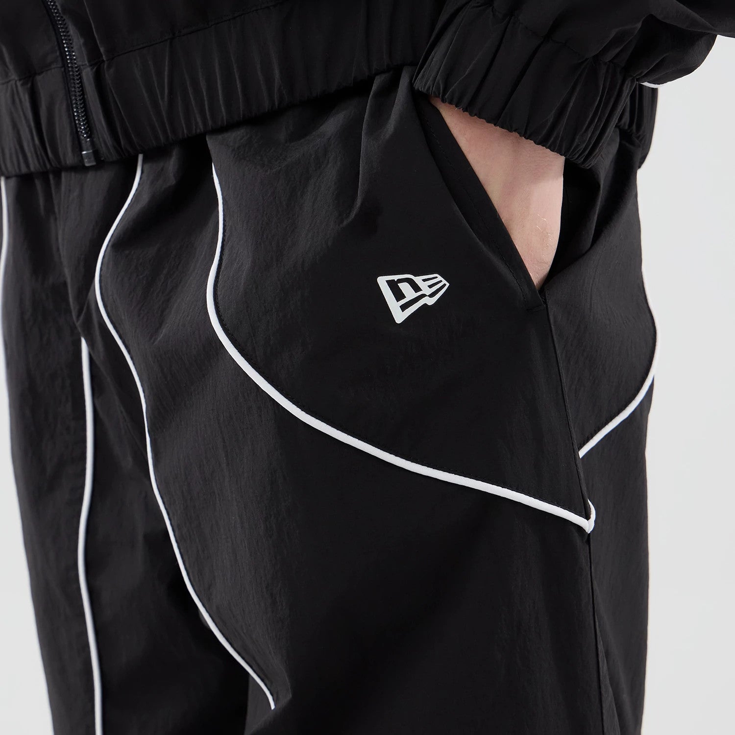 The model is wearing these MLB Piping Track LA Dodgers Track Pants in black. 6